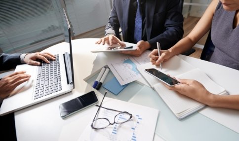 business-people-sitting-at-office-desk-working-on-project